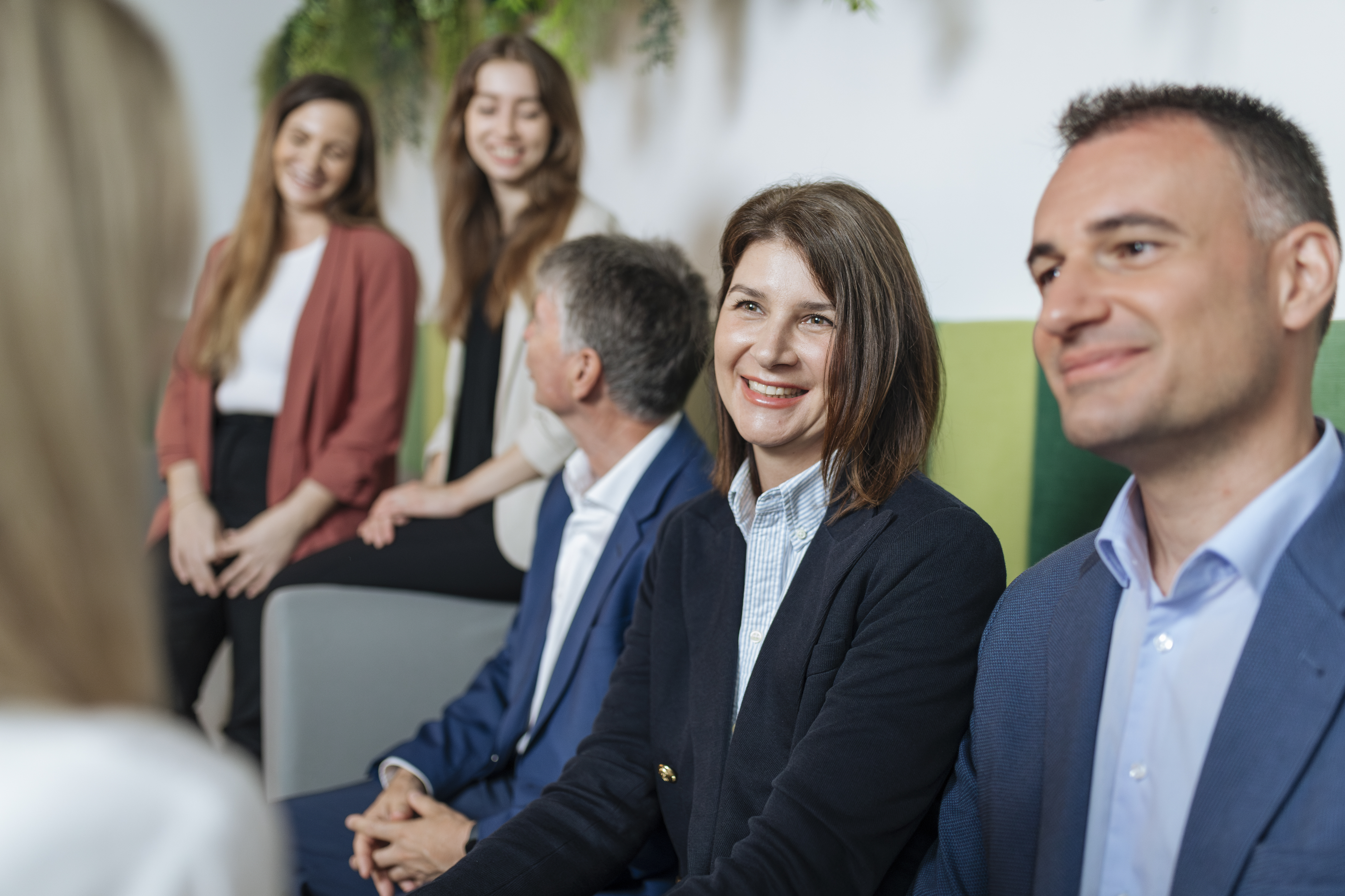 VIG employees are sitting on stairs and talking to each other