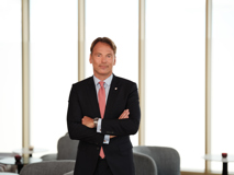 Board Member Harald Riener standing with folded arms