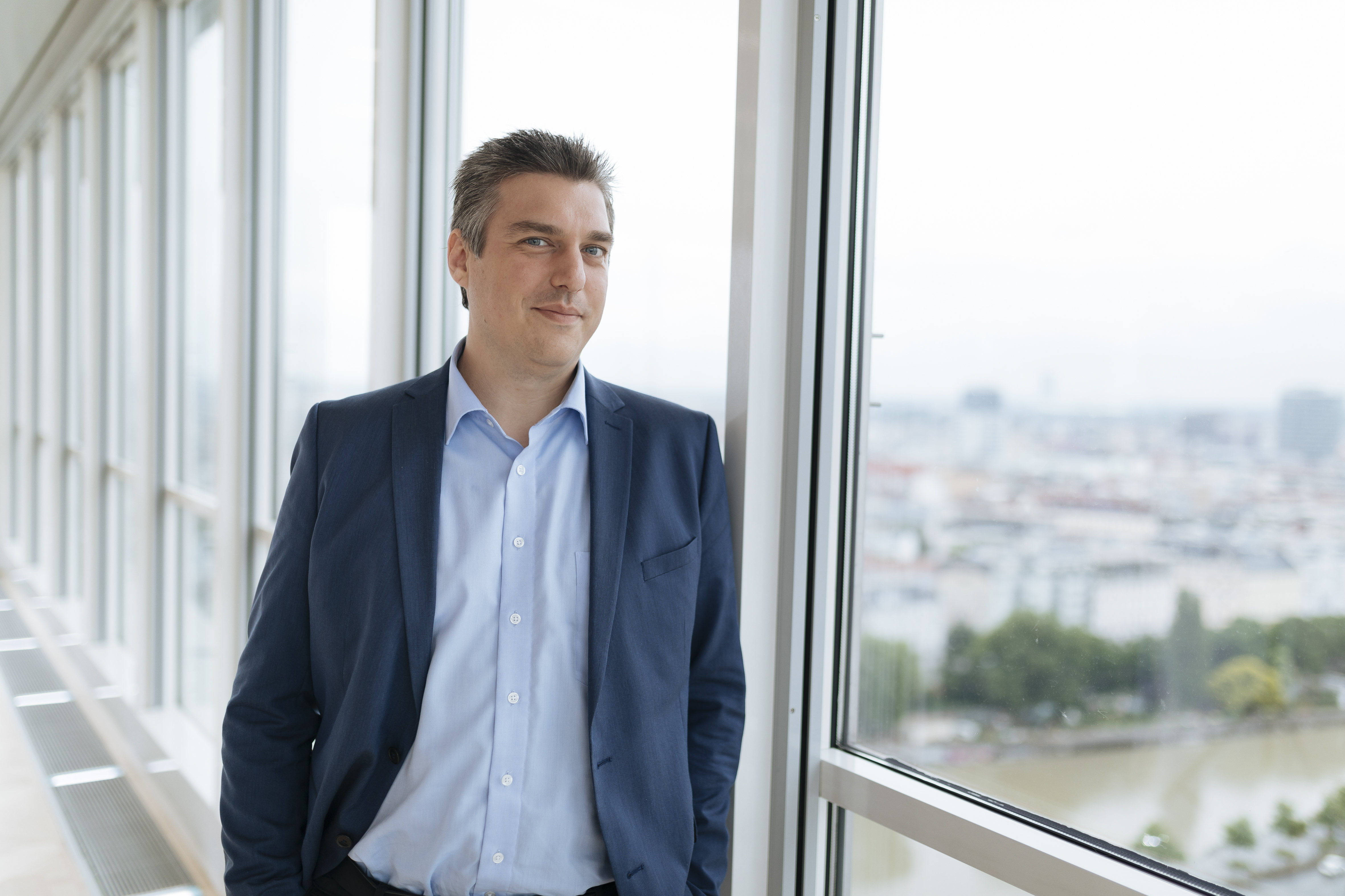 Man leaning against a window
