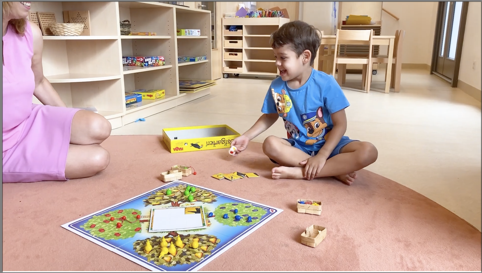 A child that plays a board game at kinder garden.