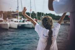 Child waving at boats of the peace fleet mirno more in the harbour