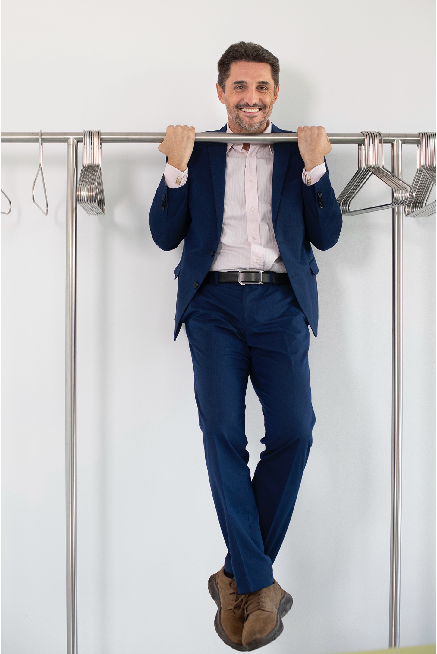 VIG Employee does a pull-up on the clothes rail