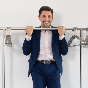 Antoniu does a pull-up on the clothes rail