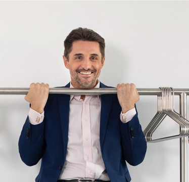 Antoniu does a pull-up on the clothes rail