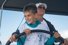 © mirno more Child pilots a boat of the peace fleet mirno more together with an adult