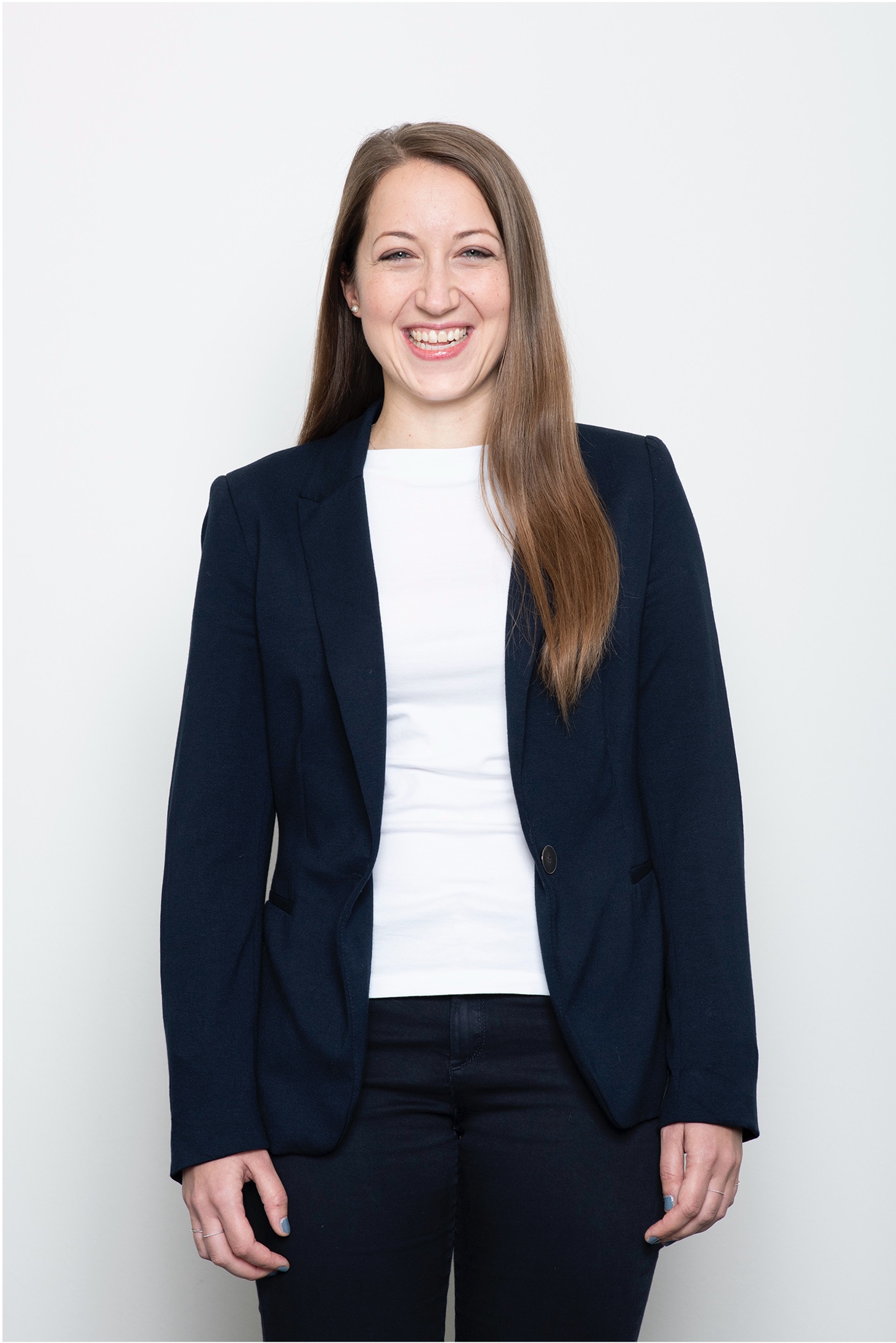 Female VIG employee standing in front of a white wall