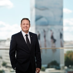 © Ian Ehm COO Gerhard Lahner stehend, im Hintergrund der Ringturm